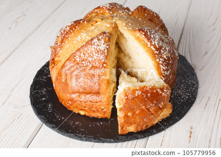 Homemade sweet brioche mouna bread close-up in a plate. horizontal Homemade sweet brioche mouna bread close-up in a plate. horizontal 105779956