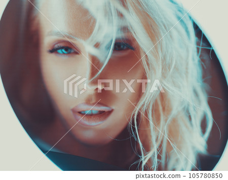 Young woman looking through pipe on camera 105780850