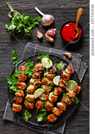 chicken souvlaki with parsley and lime on plate chicken souvlaki with parsley and lime on plate 105781656