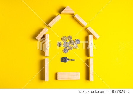 Wooden house model with coins, money, copy space on yellow background. 105782962