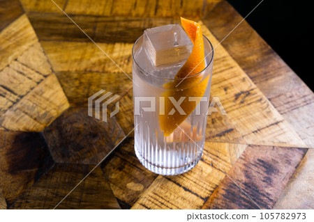 Fresh cocktail with orange and ice. Alcoholic, non-alcoholic drink-beverage at the bar counter. Fresh cocktail with orange and ice. Alcoholic, non-alcoholic drink-beverage at the bar counter. 105782973