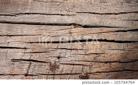 Aged and weathered wood surface with cracks 105784764