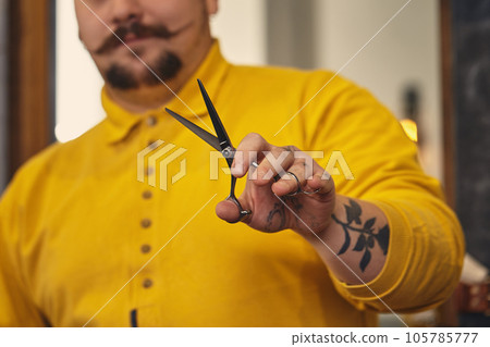 Stylish barber man with hairdressing tools in his hands prepare for work Stylish barber man with hairdressing tools in his hands prepare for work 105785777