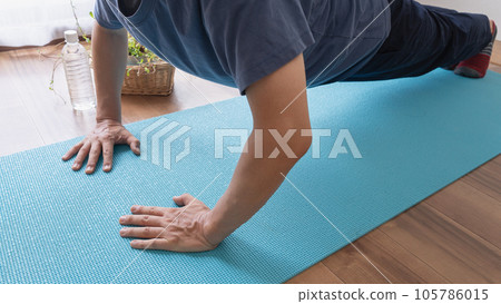 Men doing strength training on a yoga mat | Push-ups Men doing strength training on a yoga mat | Push-ups 105786015