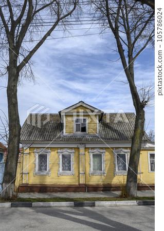 Wooden house built in 19 century with carved platbands in Gorodets, Russia 105786024