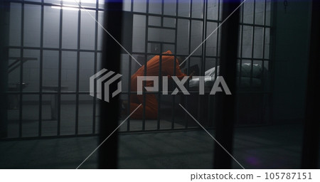 African American prisoner kneels near bed, prays to God 105787151