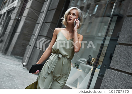 Fashion. Young stylish woman walking on the city street Fashion. Young stylish woman walking on the city street 105787870