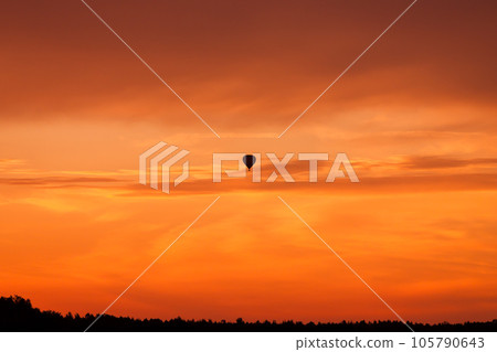 Hot air balloon flying at sunset sky 105790643