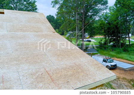During continue to build new wooden roof plywood for under construction home in construction site During continue to build new wooden roof plywood for under construction home in construction site 105790885