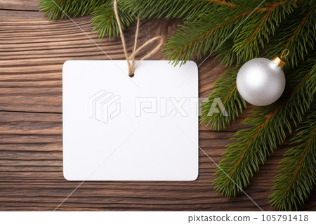 A mock-up of a white tag card a garland with Christmas tree toys A mock-up of a white tag card a garland with Christmas tree toys 105791418