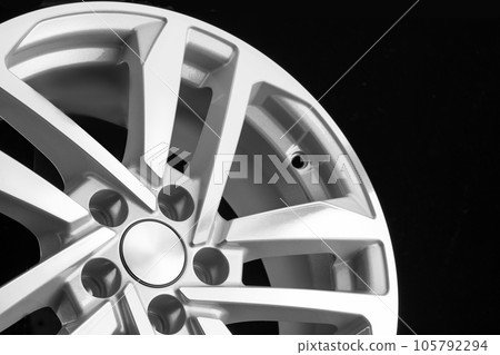 Silver aluminum wheel on a black background. close-up auto parts 105792294