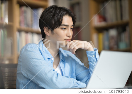University student studying in library 105793043