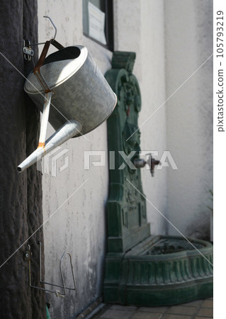 white wall and tin watering can white wall and tin watering can 105793219