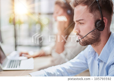 Customer Service Representative With Colleague Working In Office 105793592