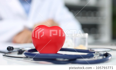 Stethoscope, red heart and cardiogram on gray table. Cardiology concept Stethoscope, red heart and cardiogram on gray table. Cardiology concept 105793771