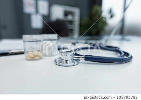 Stethoscope or phonendoscope on a doctor's white desk on cloudy morning. Treatment of cold or flu. Stethoscope or phonendoscope on a doctor's white desk on cloudy morning. Treatment of cold or flu. 105793782