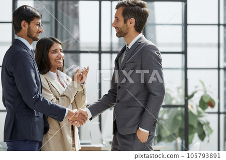 Shot of a happy businessman welcoming his new colleague to the team during a meeting in the boardroom. Shot of a happy businessman welcoming his new colleague to the team during a meeting in the boardroom. 105793891