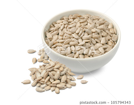 Sunflower seeds in ceramic bowl isolated on white background 105794343
