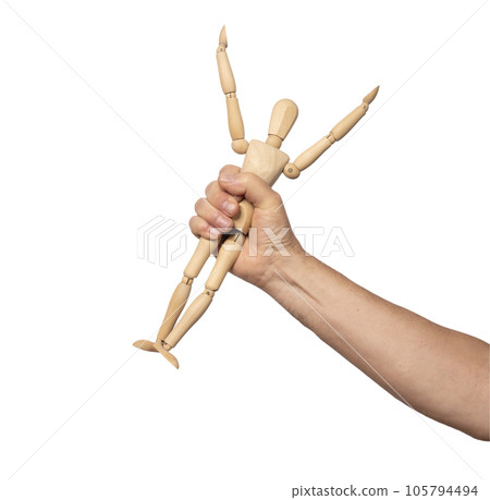a small wooden dummy in a man's hand a small wooden dummy in a man's hand 105794494