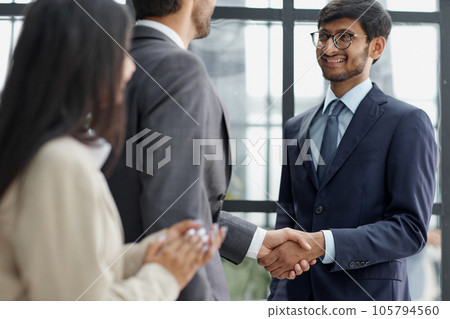 Group managers or employees standing in modern office hall after staff briefing and discussing corporate news 105794560