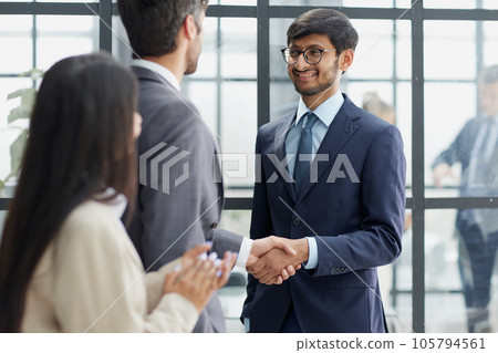Group managers or employees standing in modern office hall after staff briefing and discussing corporate news 105794561