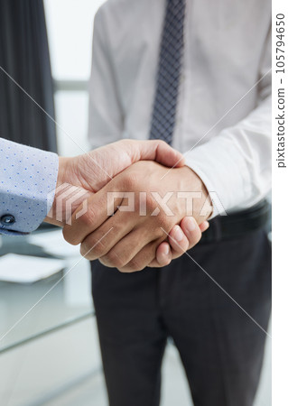 Close-up image of businesspeople shaking hand during the the meeting. 105794650