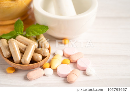 Alternative medicine herbal organic capsule with vitamin E omega 3 fish oil, mineral, drug with herbs leaf natural supplements for healthy good life. 105795667