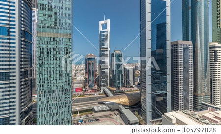 Panorama showing aerial view of Dubai International Financial District with many skyscrapers timelapse. 105797028