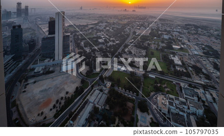 Villas in Zabeel district with skyscrapers on a background aerial night to day in Dubai, UAE Villas in Zabeel district with skyscrapers on a background aerial night to day in Dubai, UAE 105797035