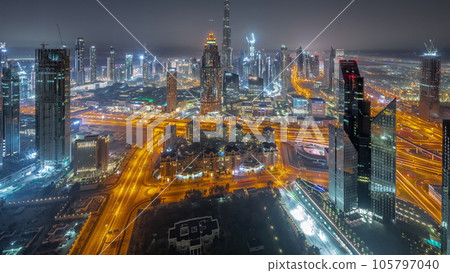 Aerial view of tallest towers in Dubai Downtown skyline and highway all night timelapse. Aerial view of tallest towers in Dubai Downtown skyline and highway all night timelapse. 105797040