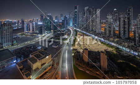 Panorama showing Bay Avenue with modern towers residential development in Business Bay aerial night timelapse, Dubai 105797058