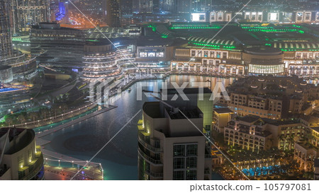 Dubai promenade singing fountains on the background of architecture aerial timelapse 105797081
