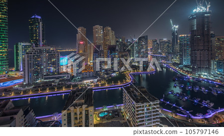 Panorama showing Dubai Marina skyscrapers and JBR district with luxury buildings and resorts aerial night timelapse Panorama showing Dubai Marina skyscrapers and JBR district with luxury buildings and resorts aerial night timelapse 105797146