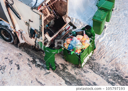 garbage collection workers pick up household waste in winter 105797193