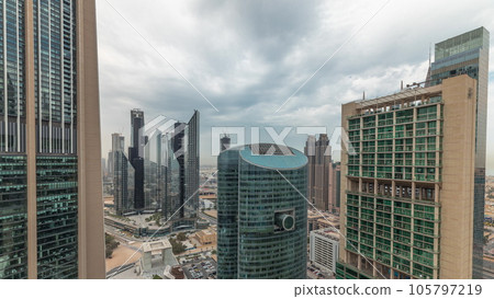 Panorama showing Dubai international financial center skyscrapers with promenade on a gate avenue aerial timelapse. Panorama showing Dubai international financial center skyscrapers with promenade on a gate avenue aerial timelapse. 105797219