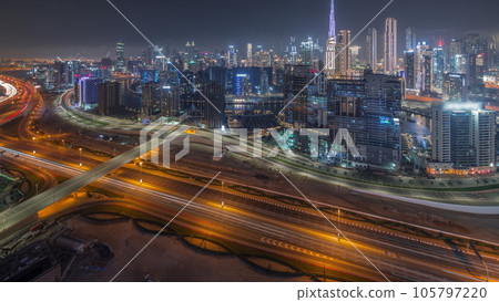 Skyline with modern architecture of Dubai business bay towers day to night timelapse. Aerial view Skyline with modern architecture of Dubai business bay towers day to night timelapse. Aerial view 105797220