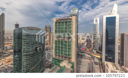 Panorama showing Dubai international financial center skyscrapers with promenade on a gate avenue aerial timelapse. Panorama showing Dubai international financial center skyscrapers with promenade on a gate avenue aerial timelapse. 105797221