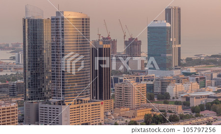 Office buildings in Dubai Internet City and Media City district aerial night to day timelapse 105797256