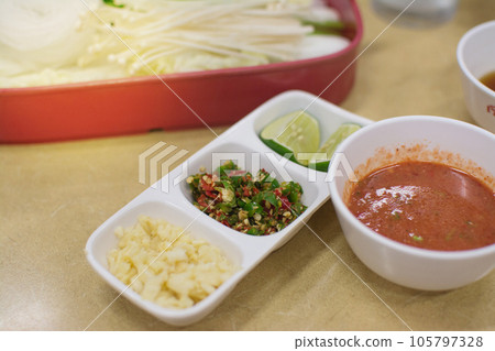 suki sauce in bowl with topping , Chopped chilli, Garlic alley on table ,Thai style food 105797328