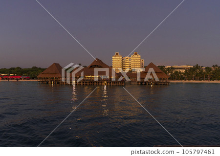 thatch stilt house restaurant at Kendwa beach at evening 105797461