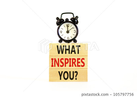 What inspires you symbol. Concept words What inspires you on wooden block. Beautiful white table white background. Black alarm clock. Business motivational what inspires you concept. Copy space. 105797756