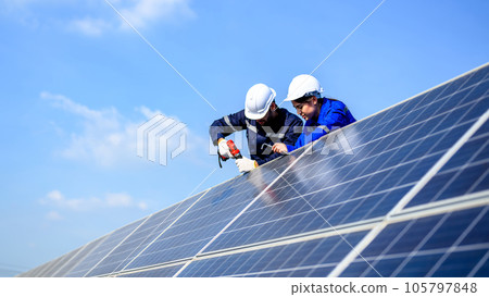 Technicians workers installing solar panels at solar cell farm Technicians workers installing solar panels at solar cell farm 105797848