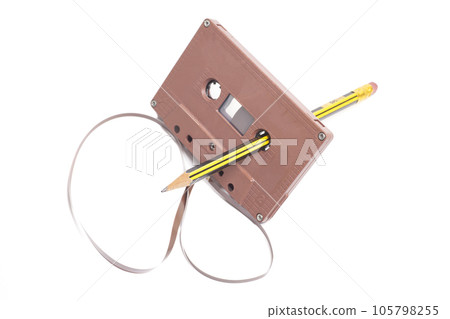 Audio cassette tape with pencil isolated on white background, vintage 80's music concept 105798255