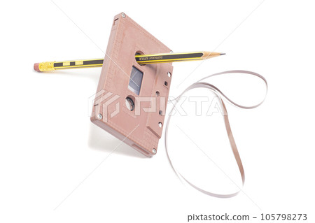 Audio cassette tape with pencil isolated on white background, vintage 80's music concept Audio cassette tape with pencil isolated on white background, vintage 80's music concept 105798273