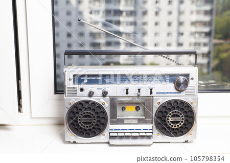 Silver retro ghetto radio boom box cassette recorder from 80s on the on window sills 105798354