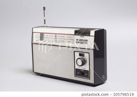 Vintage transistor radio on a gray background 105798519
