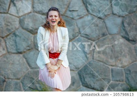 smiling stylish 40 years old woman in dress and jacket in city smiling stylish 40 years old woman in dress and jacket in city 105798613