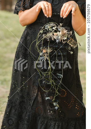 The bride holds her wedding bouquet in her hands The bride holds her wedding bouquet in her hands 105798679
