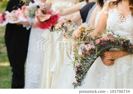 Many brides hold their wedding bouquet in their hands Many brides hold their wedding bouquet in their hands 105798734