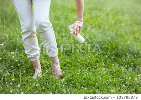 Closeup on woman using repellent spray Closeup on woman using repellent spray 105798879